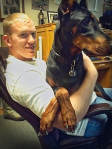 John Walter and Cooper sitting on a chair together.